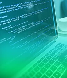 hands writing code on a computer